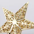 Close-up of a 15cm golden hollowed-out five-pointed star Christmas tree topper - 15cm / Gold