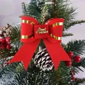 Detail view of red velvet Christmas bow with gold Merry Christmas script on tree - 9*11cm / Red