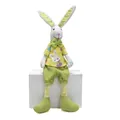 Handmade plush Easter bunny decoration sitting on white box for spring home layout - Male Style