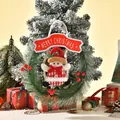 Detailed view of a mini Christmas pine wreath with a plush snowman figure decoration. - Snowman Style (195B) / 27x32cm