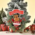Detail of Christmas reindeer ornament hanging on frosted pine tree with gifts - Reindeer Style (195c) / 27x32cm
