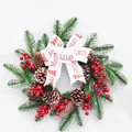 Festive Christmas wreath featuring PE needles, red berries, pine cones, and a decorative ribbon - 40cm Small Wreath