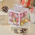 Close-up of a clear Christmas gift box filled with festive ornaments and bells - Candy Canes and Bells Set (WRB544329) / 8x8x8cm