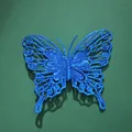 Macro detail of a blue glitter butterfly ornament for party and wedding wall decor. - 10cm / Blue