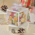 Transparent Christmas gift box filled with gold and green miniature festive ornaments on snow. - Mini Drums and Gift Boxes Set (WRB544426) / 8x8x8cm