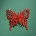 Detailed view of red glitter butterfly decoration for festive wall arrangements - 12cm / Red