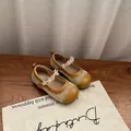 Detail of girls' mustard yellow Mary Jane flats with mesh and crystal floral strap. - 22 / Yellow