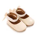 Detailed macro shot of cream baby princess shoes with faux pearl trim and ribbon bows - Inner Length 11cm / Apricot