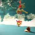 Detailed view of a golden reindeer Christmas ornament with bells and festive red bows - Flying Reindeer / Gold