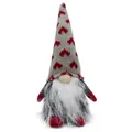 Detailed macro view of a Christmas gnome doll featuring a heart-patterned grey knitted hat. - Heart