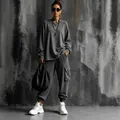 Model wearing women's charcoal gray oversized top and cargo jogger two-piece set - S / Top And Bottom / Long Sleeve Grey