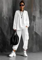 Stylish full-body view of women's white oversized two-piece set with cargo pockets - S / Top And Bottom / Long Sleeve White