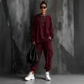Full-length view of a stylish burgundy tracksuit with cargo pants and oversized sweatshirt. - S / Top And Bottom / Long Sleeve Wine Red
