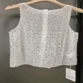 Elegant white sequined sleeveless vest top for women featuring shimmering beadwork detail - S / Tops / White