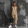 Model wearing a beige two-piece cargo streetwear set with sleeveless top and pants - S / Top And Bottom / Khaki