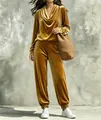 Detailed view of women's gold velvet tracksuit with cowl neck top and jogger pants - Gold