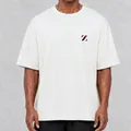 Close-up detail of oversized cream cotton T-shirt with chest logo emblem - S / Tops / White