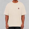 Detail shot of an oversized washed cotton t-shirt in beige featuring a minimalist chest logo. - S / Tops / Apricot