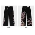 Detailed front and back views of black straight-leg jeans with cherry blossom embroidery. - XS / Bottoms / Black Knight Embroidery (VCT-6)