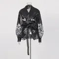 Detail of black floral palace lantern sleeve blouse with tie waist and lapel - S / Tops / Black