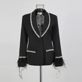 Detail of black blazer featuring ostrich feather cuffs and rhinestone trim accents - M / Tops / Black