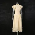 Close-up detail of vintage cream two-piece set featuring ruffled sleeves and elegant lace hem - S / Top And Bottom / Apricot
