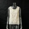 Detailed view of heavy beadwork and floral embroidery on a white luxury tank top. - S / Tops / Apricot