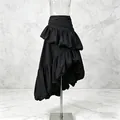 Detailed view of the layered ruffles and asymmetrical hem on this black midi skirt - S / Black