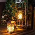 Warm yellow glowing vintage solar lanterns hanging in a decorative garden at night. - Large Lantern Bronze with Transparent Cover