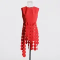 Detail view of a vibrant red sleeveless top with a unique circular fringe design - S / Tops / Red