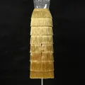 Detailed view of a golden tiered fringe long skirt featuring a stylish high waist design - M / Bottoms / Gold