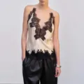 Detailed view of elegant French style V-neck silk camisole with black lace trim - S / Tops / Apricot
