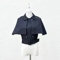Detailed macro view of navy blue cropped vest with detachable cape and belted waist - S / Tops / Black