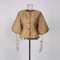 Detailed view of a French style gold tweed round neck jacket with puff sleeves on a mannequin - M / Tops