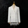 Detailed view of white blazer with elegant ostrich feathers and sequin shell trim. - M / Tops / White