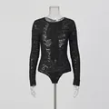 Close-up view of a sexy black sheer lace bodysuit featuring intricate floral patterns - S / Tops / Black