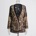 Detailed view of the royal style blazer with heavy gold print and pearl beadwork. - S / Tops / Yellow