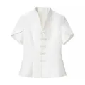 Detailed view of a white modern Chinese top with frog buttons and stand collar. - S / Tops / White