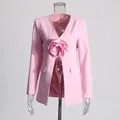 Close-up of pink blazer featuring a large 3D flower and elegant slim-fit waist design - Pink