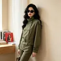 Detail of a British retro short trench coat in olive green with a belted waist. - S / Tops / Army Green