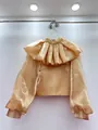 Detailed view of the champagne gold blouse featuring a large pleated ruff collar. - One Size / Tops / Champagne