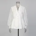 Front view of elegant white V-neck blouse with pearl shoulder embroidery details - M / Tops / White