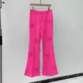 Vibrant fuchsia pink flared trousers featuring elegant 3D floral appliqués for women - S / Bottoms / Pink