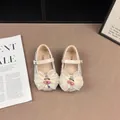 Detailed view of sparkly Mary Jane shoes with organza bows and cherry charms - Off White