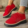 Primo piano della trama fly-knit e del design stringato delle sneakers rosse platform - Rosso