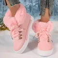 Detail view of pink faux fur trim snow boots for women with thick soles and lace-up design. - Pink