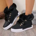 Detailed view of black faux fur lined snow boots with durable white platform soles - 36 / Black