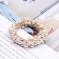 Detailed close-up view of elegant cream pearl beaded hair tie on stylish magazine background - Champagne