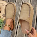 Close-up of tan suede platform clogs with decorative stitching and wood background - 36 / Khaki