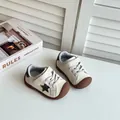 Stylish minimalist toddler sneakers in cream and brown featuring a black star accent - Size 22 Inner Length 14.5CM / Beige